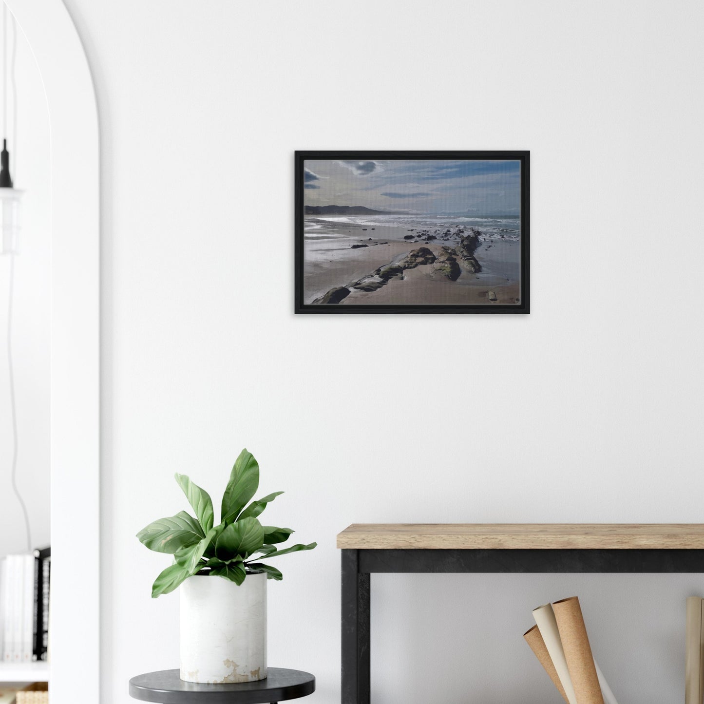 A moody, windswept beach and a line of sea-weathered rocks stretching into the distance, this artwork captures the raw, untouched feel of a wild shoreline.