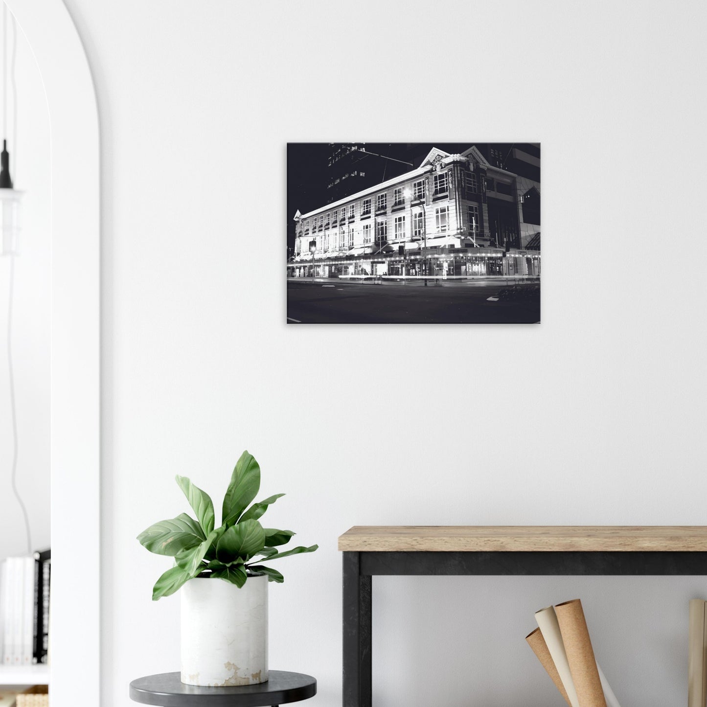 Monochrome artwork of Wellington’s Kirkaldie and Stains building lit at night, showcasing historic architectural details.