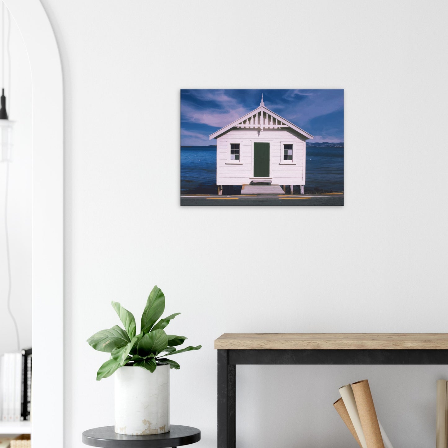 White boat shed by the sea under a blue sky in Eastbourne, New Zealand – bright and coastal.