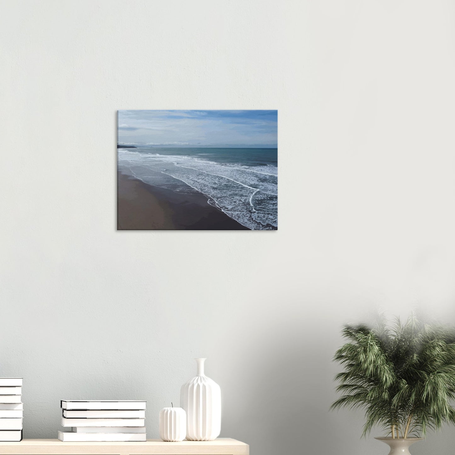 Soft, muted tones of sand, seafoam, and sky blend together in a calming composition, highlighting the natural rhythm of waves lapping the shore.