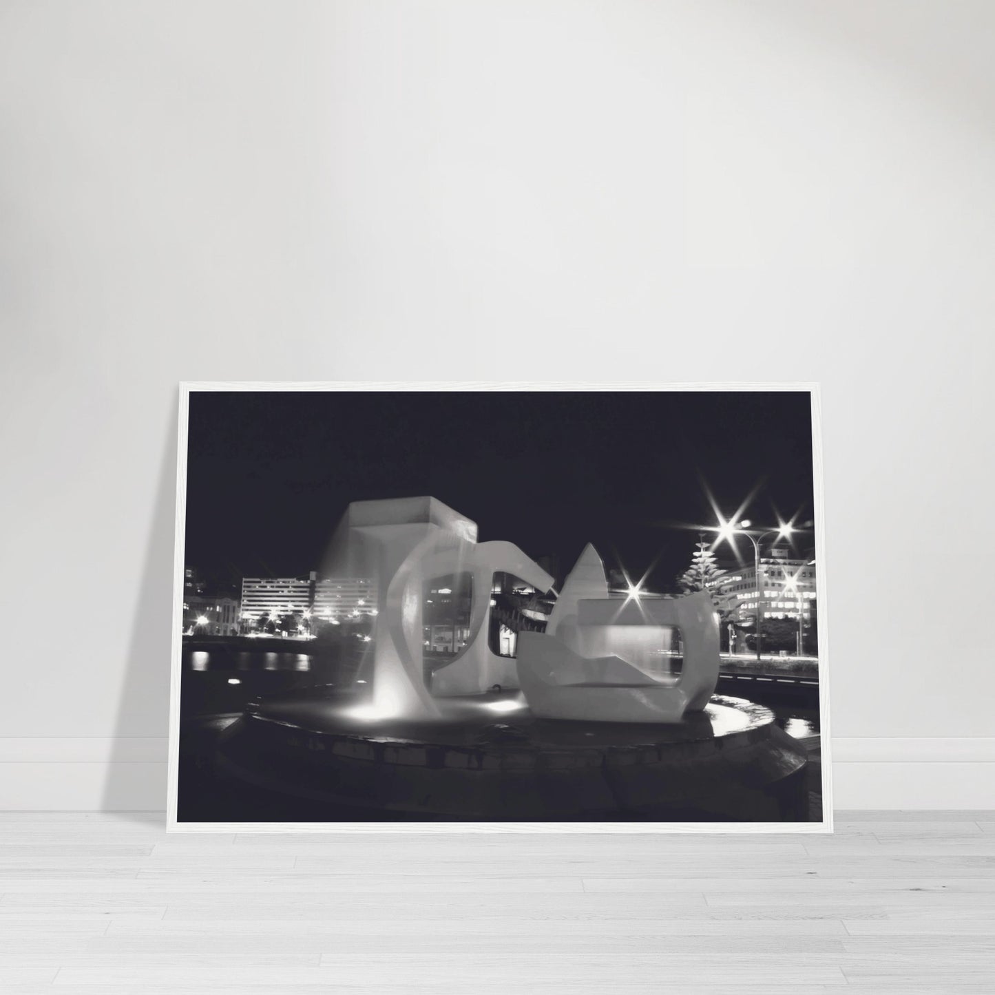Monochrome artwork of Wellington’s Albatross Fountain lit at night, featuring bold sculptural lines and soft lighting.