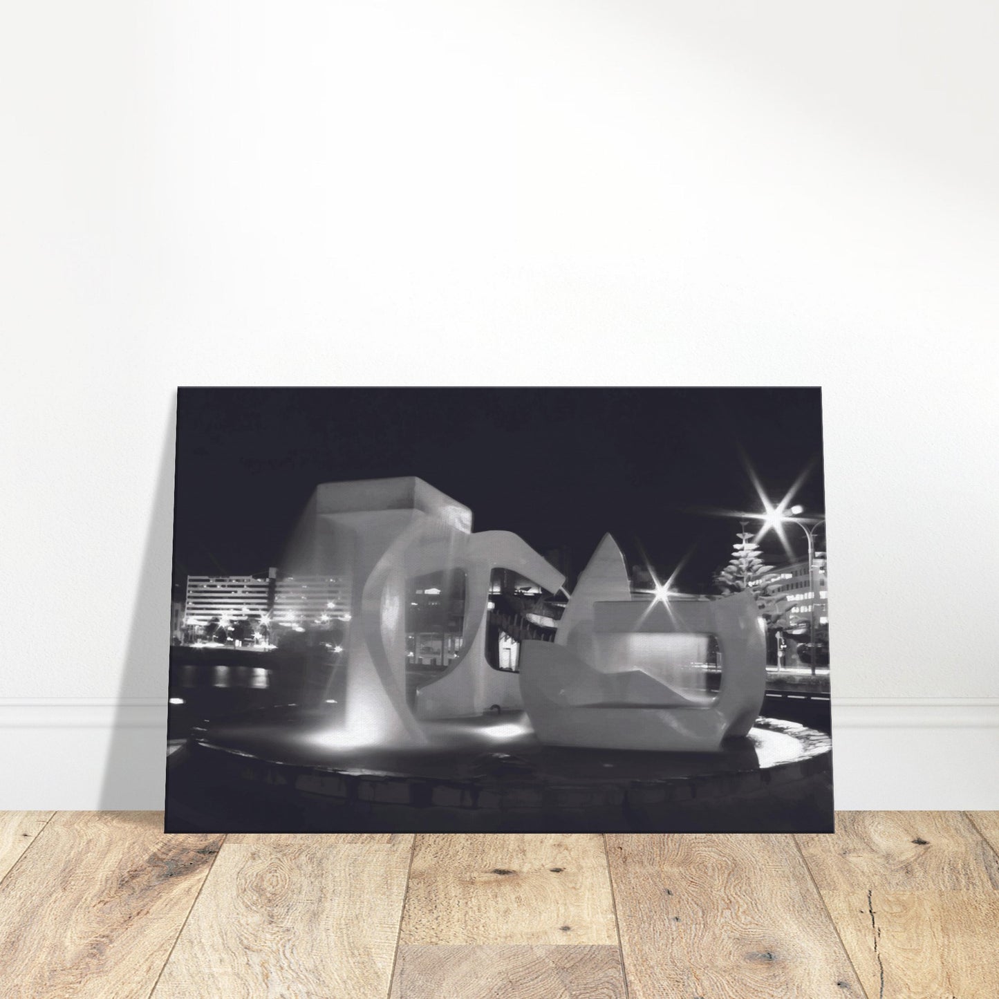 Monochrome artwork of Wellington’s Albatross Fountain lit at night, featuring bold sculptural lines and soft lighting.