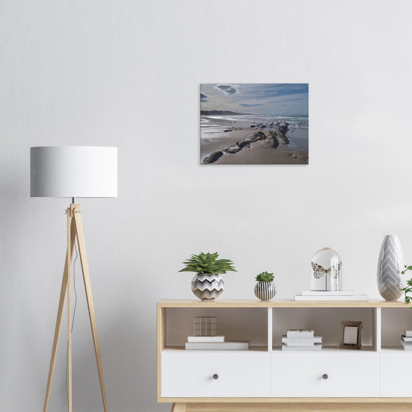 A moody, windswept beach and a line of sea-weathered rocks stretching into the distance, this artwork captures the raw, untouched feel of a wild shoreline.