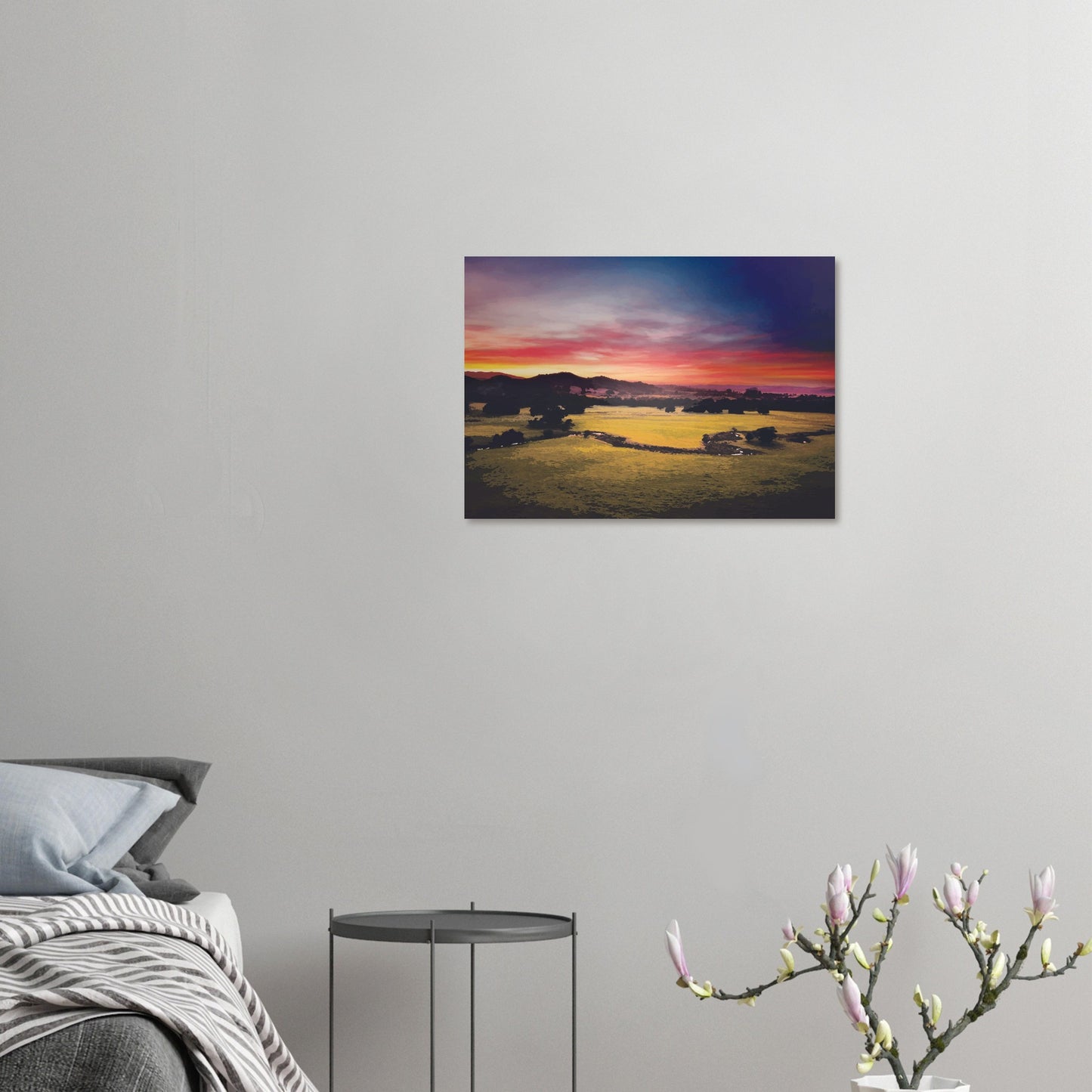 Sunrise over green fields and hills in Wairarapa, with glowing skies in purple, orange, and pink.