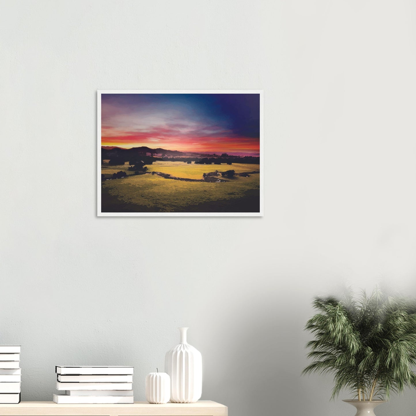 Sunrise over green fields and hills in Wairarapa, with glowing skies in purple, orange, and pink.
