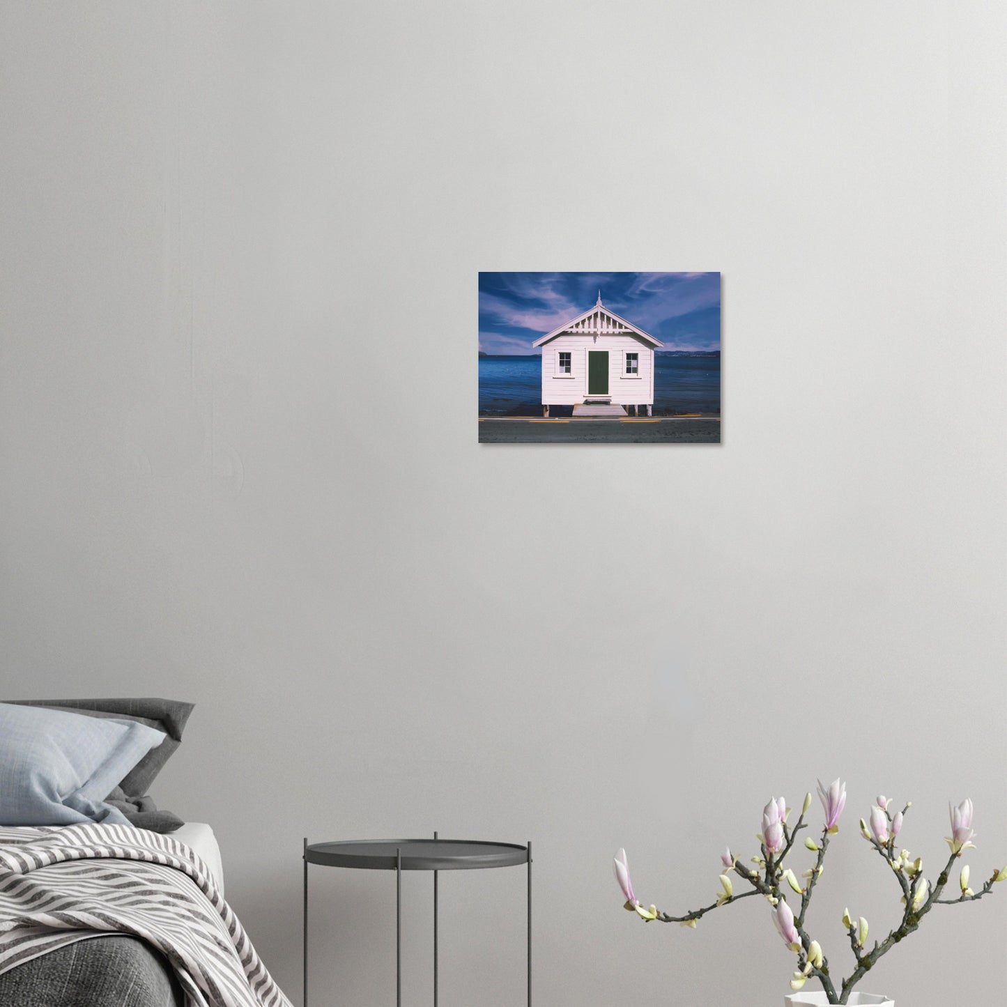 White boat shed by the sea under a blue sky in Eastbourne, New Zealand – bright and coastal.