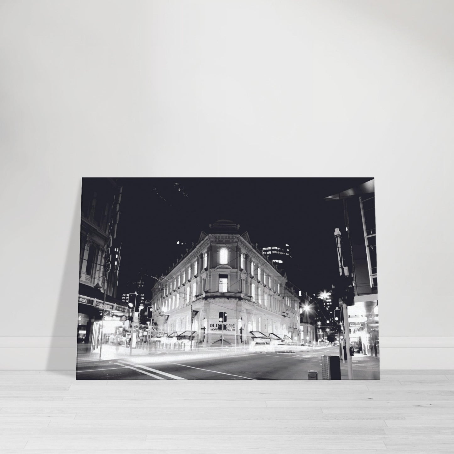 Monochrome artwork of Wellington’s Old Bank Arcade lit up at night, with glowing windows and a classic architectural facade.