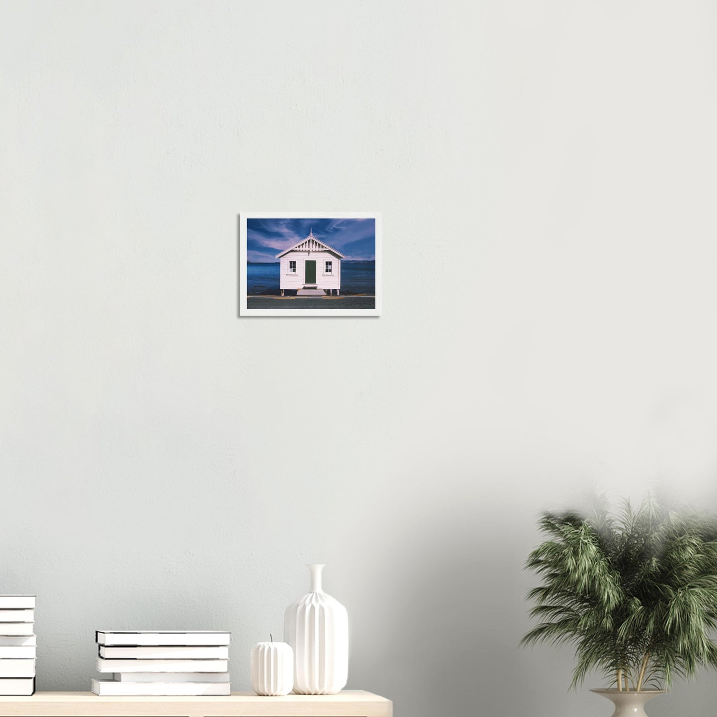 White boat shed by the sea under a blue sky in Eastbourne, New Zealand – bright and coastal.