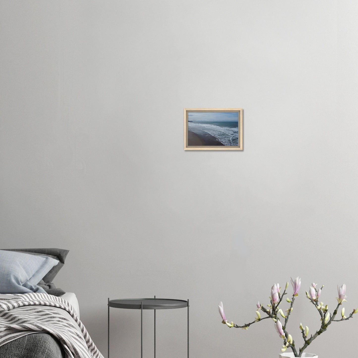 Soft, muted tones of sand, seafoam, and sky blend together in a calming composition, highlighting the natural rhythm of waves lapping the shore.