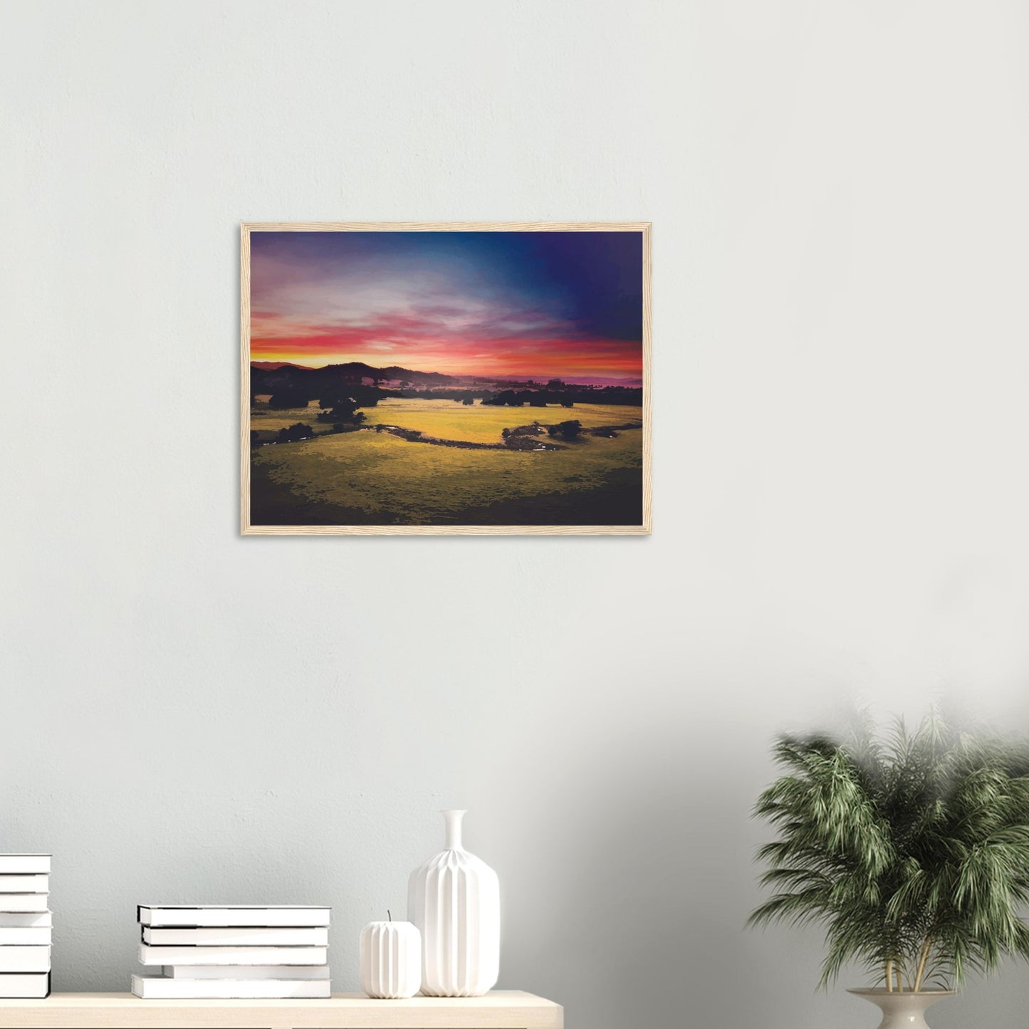 Sunrise over green fields and hills in Wairarapa, with glowing skies in purple, orange, and pink.