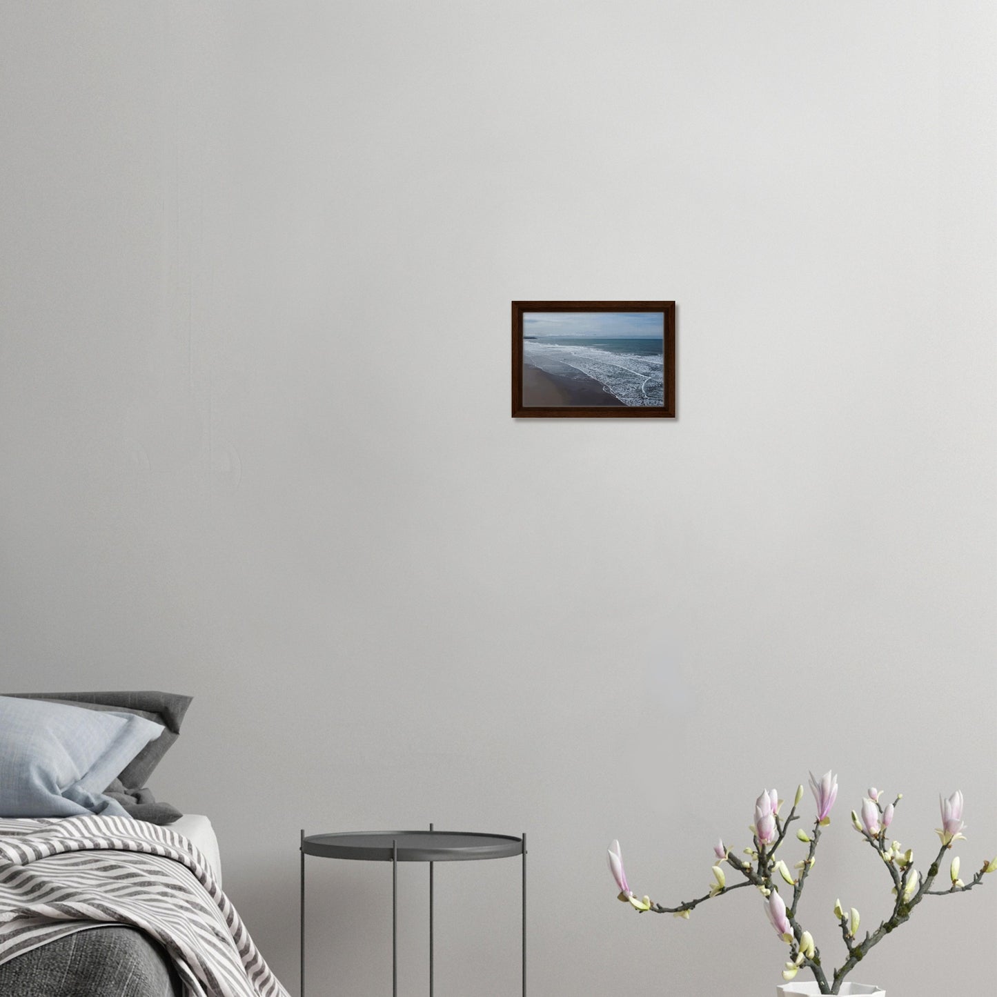 Soft, muted tones of sand, seafoam, and sky blend together in a calming composition, highlighting the natural rhythm of waves lapping the shore.