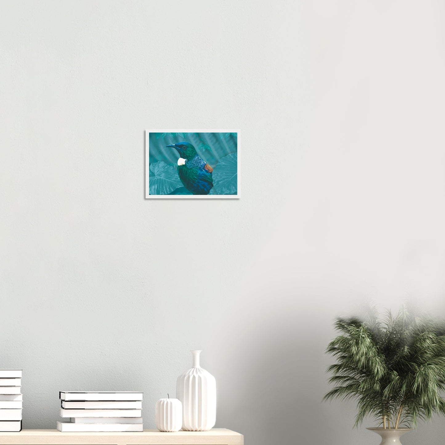 With rich teal and emerald hues and the tūī’s signature white throat tufts, the artwork evokes the dappled light of the forest and the bird’s melodic presence among the trees.