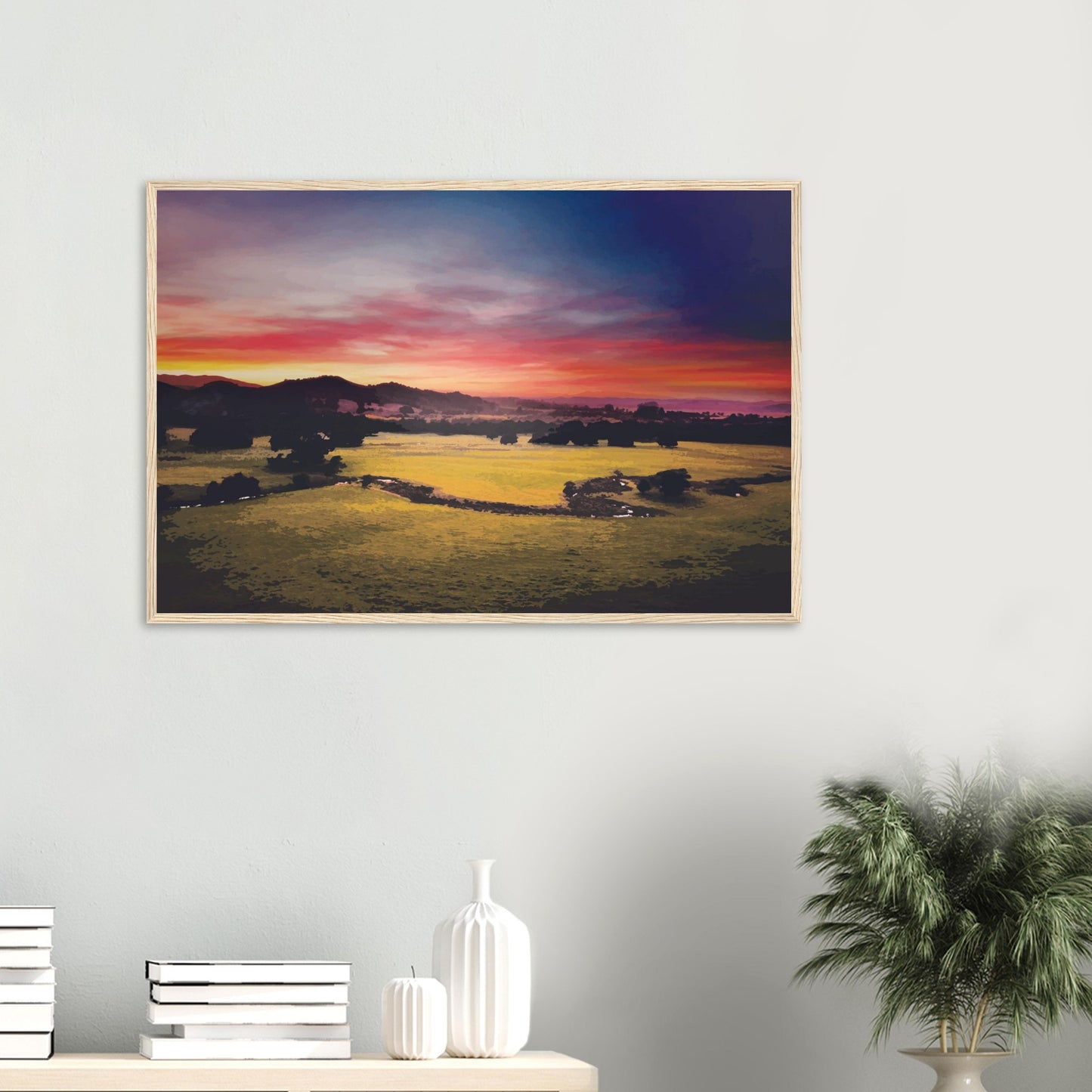 Sunrise over green fields and hills in Wairarapa, with glowing skies in purple, orange, and pink.