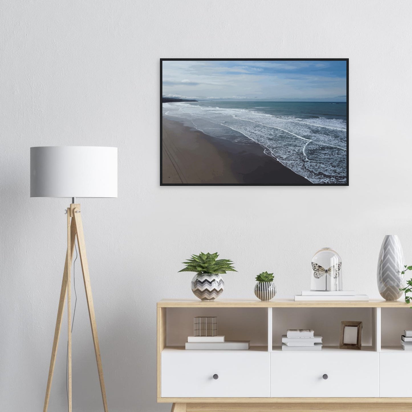 Soft, muted tones of sand, seafoam, and sky blend together in a calming composition, highlighting the natural rhythm of waves lapping the shore.