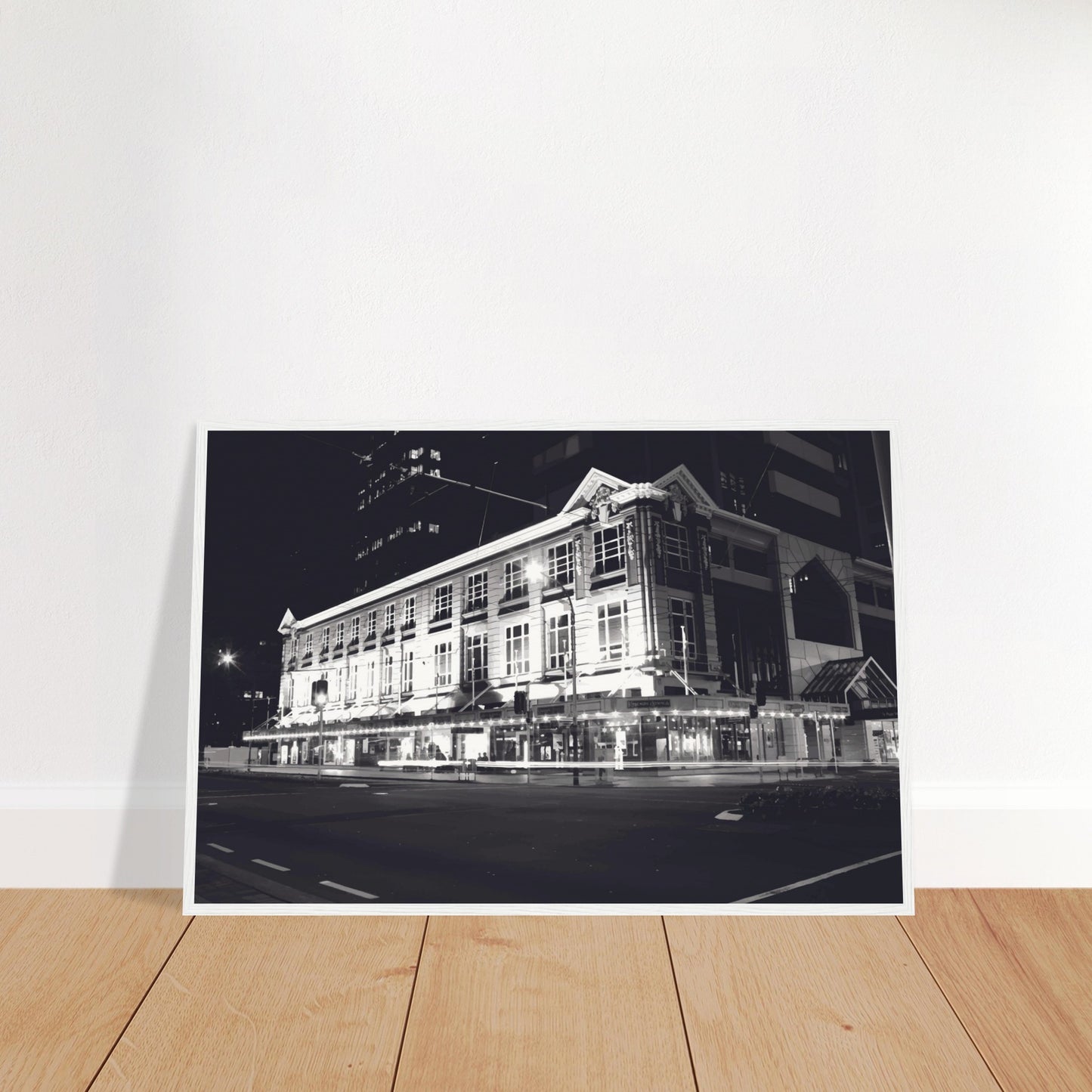 Monochrome artwork of Wellington’s Kirkaldie and Stains building lit at night, showcasing historic architectural details.