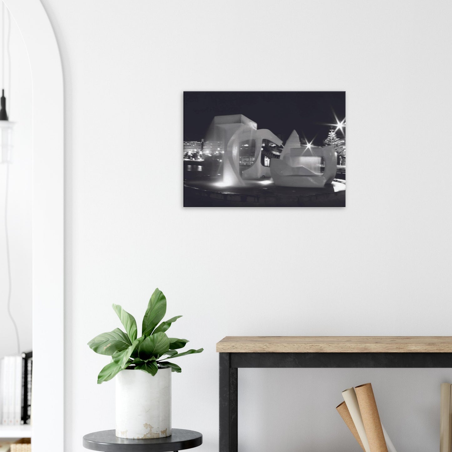 Monochrome artwork of Wellington’s Albatross Fountain lit at night, featuring bold sculptural lines and soft lighting.