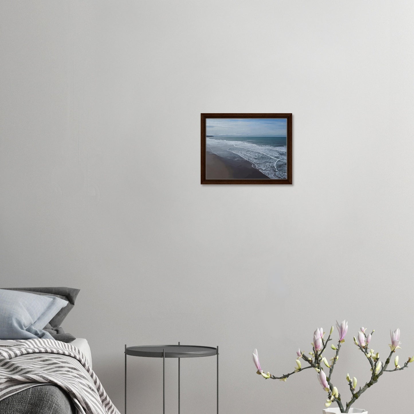 Soft, muted tones of sand, seafoam, and sky blend together in a calming composition, highlighting the natural rhythm of waves lapping the shore.