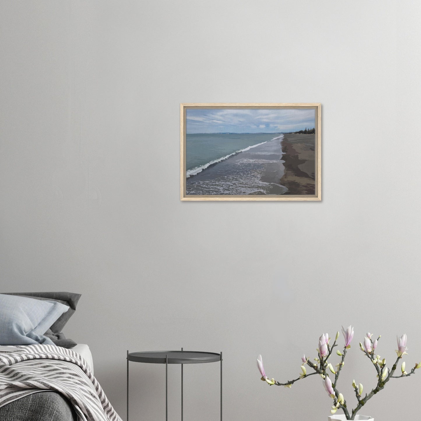 Gentle waves roll onto the dark sand, stretching endlessly into the distance under a softly clouded sky. Hints of pine trees and distant land complete the scene