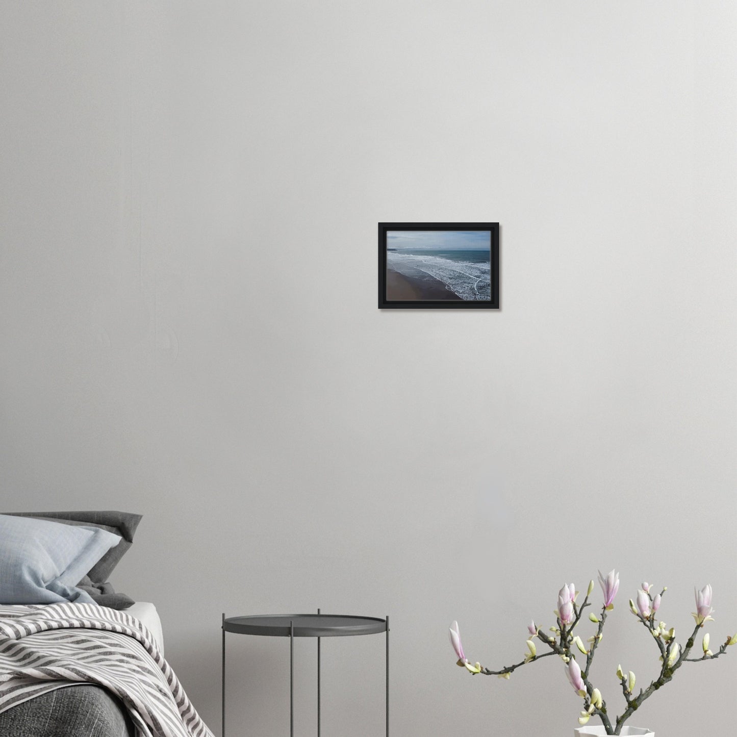 Soft, muted tones of sand, seafoam, and sky blend together in a calming composition, highlighting the natural rhythm of waves lapping the shore.