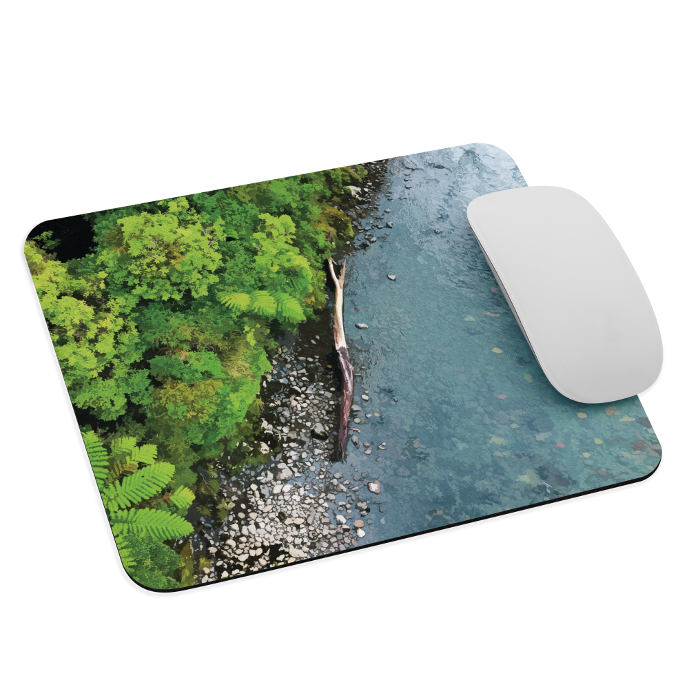Resting Place mouse pad with aerial artwork of river rocks, green bush, and driftwood in a New Zealand stream.
