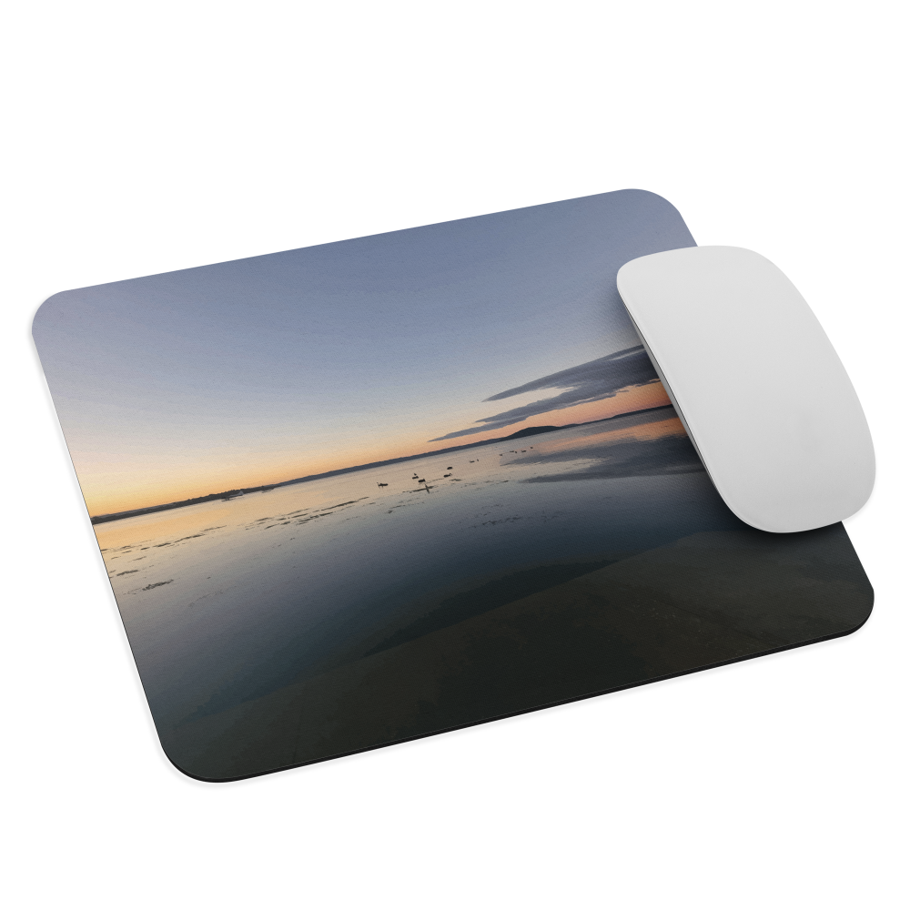 Mouse pad with tranquil lake scene at sunrise and distant hills.