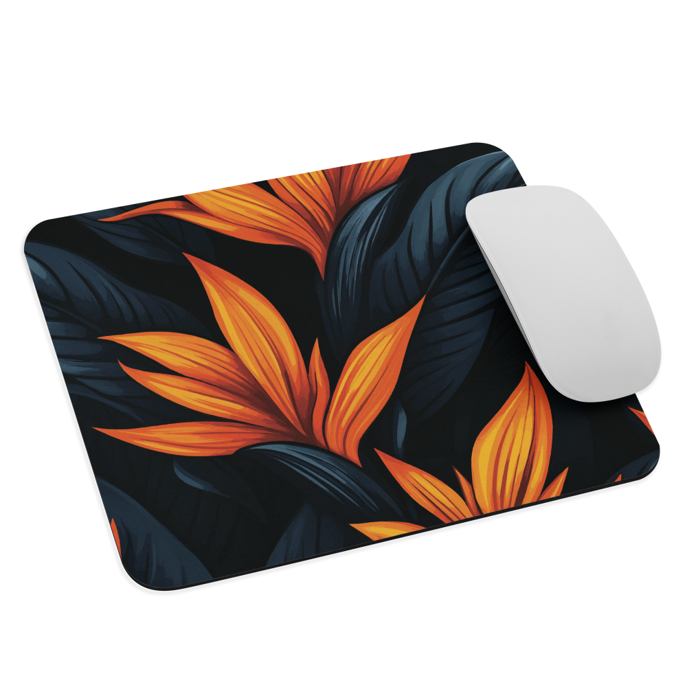 Mouse pad with bold orange bird of paradise flowers on dark background.