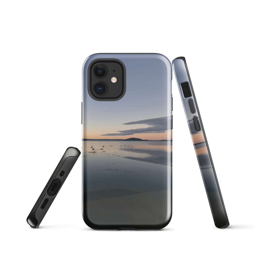 Phone case with tranquil lake scene at sunrise and distant hills.