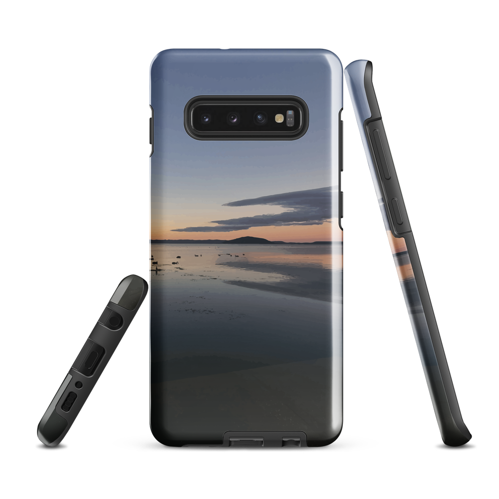 Phone case with tranquil lake scene at sunrise and distant hills.