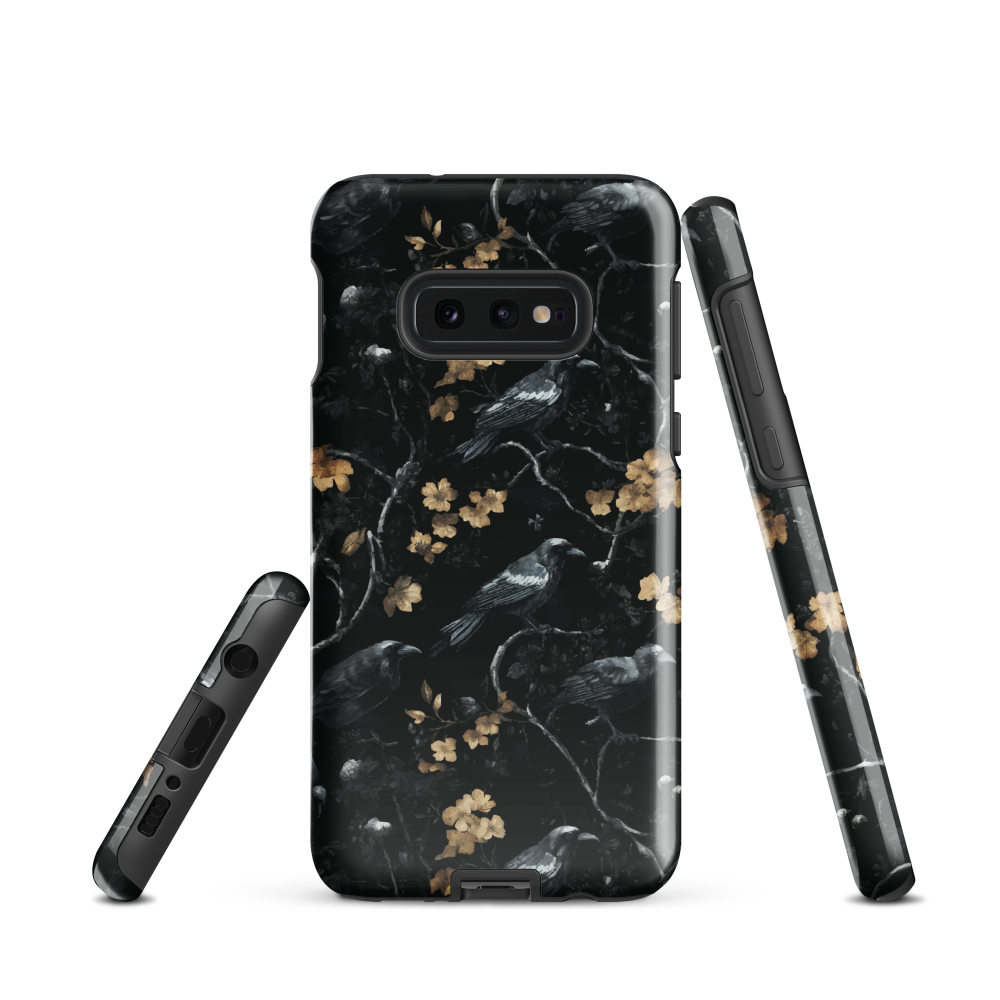 Dark phone case with blackbirds and gold blossoms on black branches.