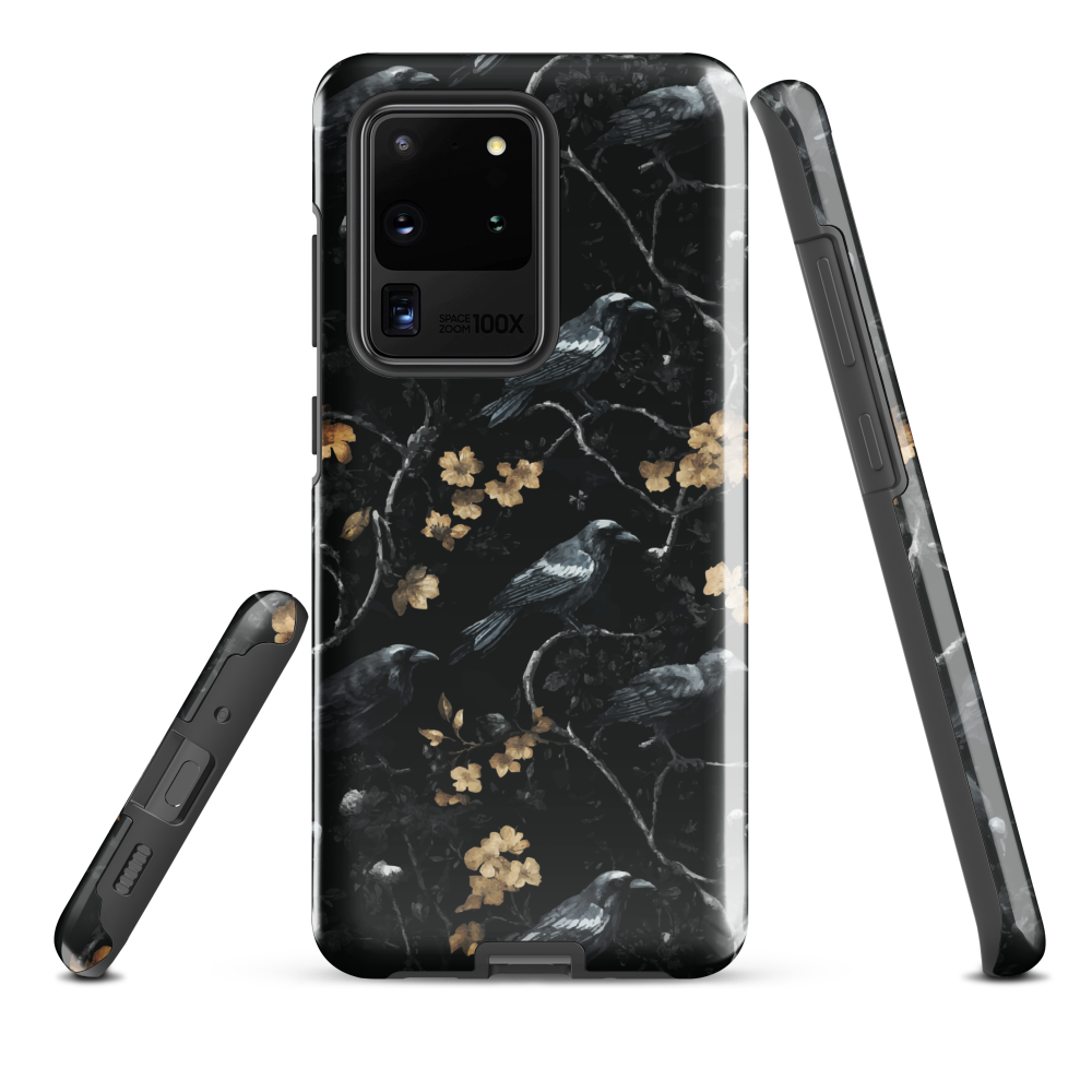 Dark phone case with blackbirds and gold blossoms on black branches.
