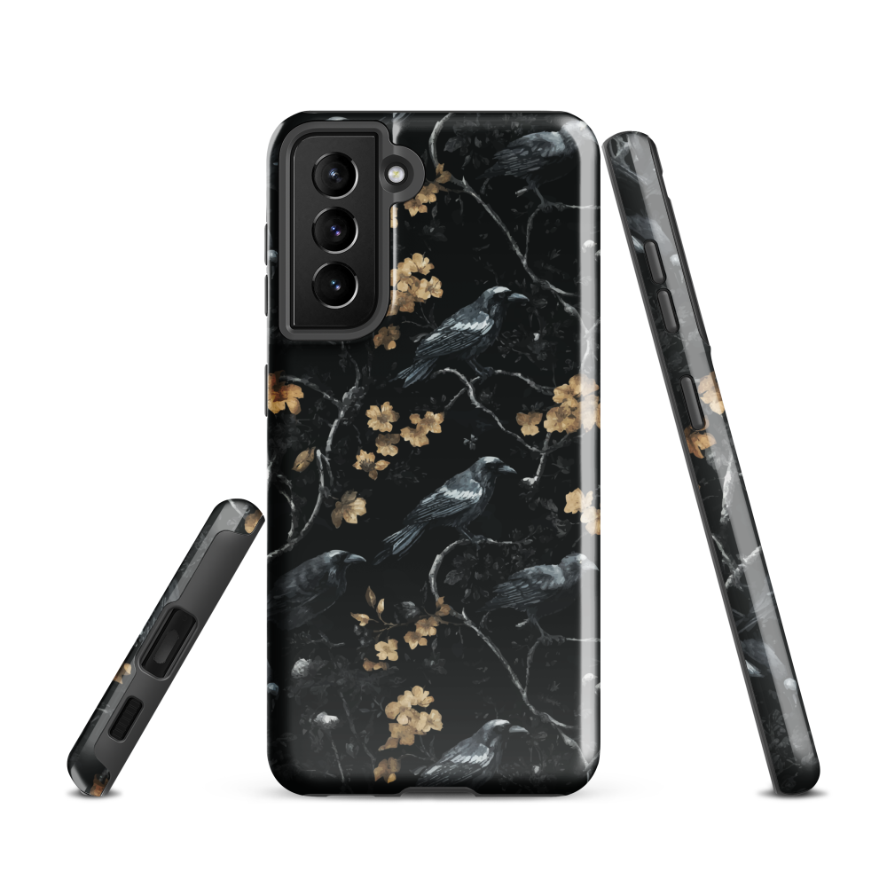 Dark phone case with blackbirds and gold blossoms on black branches.