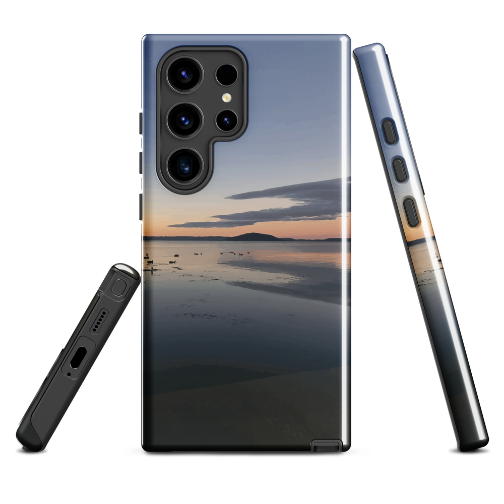 Phone case with tranquil lake scene at sunrise and distant hills.