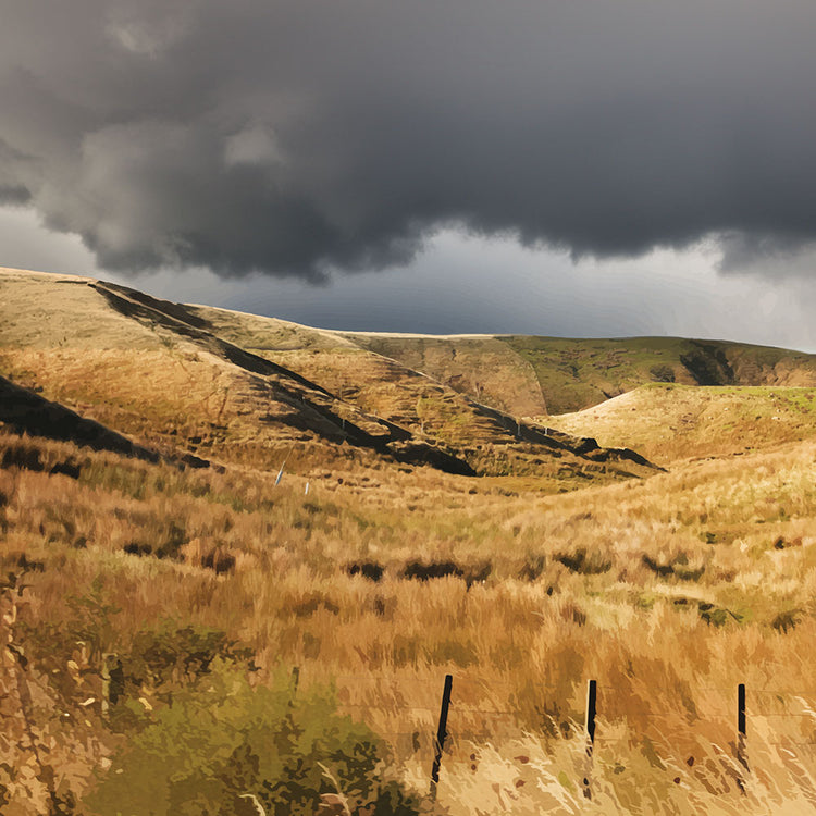 Golden Hawke’s Bay hills beneath dark clouds in a nostalgic NZ landscape artwork titled Trip Home by Ben Hart.