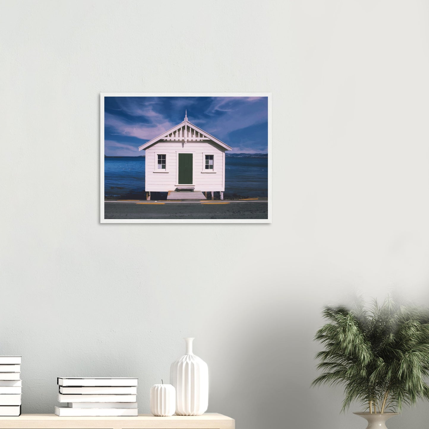 White boat shed by the sea under a blue sky in Eastbourne, New Zealand – bright and coastal.