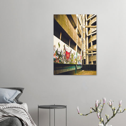 Graffiti-covered alley with concrete walls and fence, full of urban texture and raw colour.