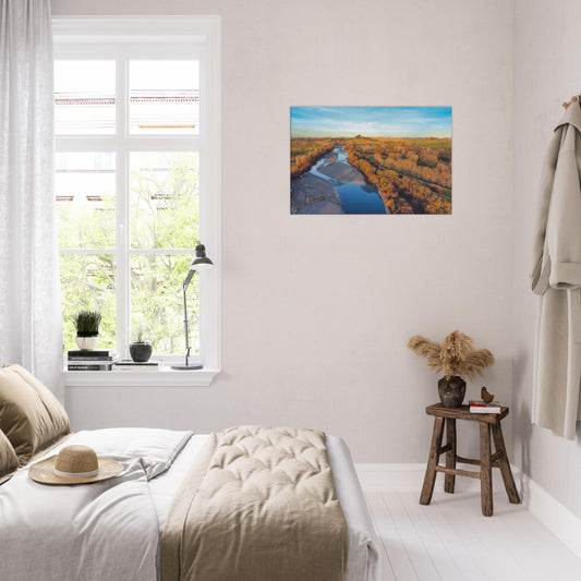 Aerial artwork of the Tukituki River winding through farmland, glowing in golden light with blue water reflections.