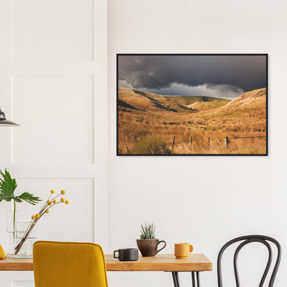 Golden Hawke’s Bay hills beneath dark clouds in a nostalgic NZ landscape artwork titled Trip Home by Ben Hart.
