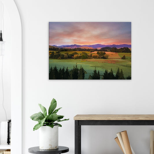 Artwork of a Wairarapa sunrise over pine trees and rolling farmland with soft light on the Tararua Ranges.