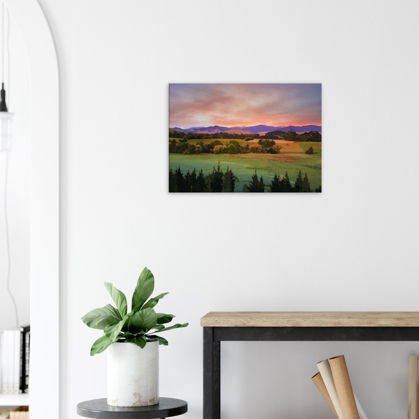Artwork of a Wairarapa sunrise over pine trees and rolling farmland with soft light on the Tararua Ranges.