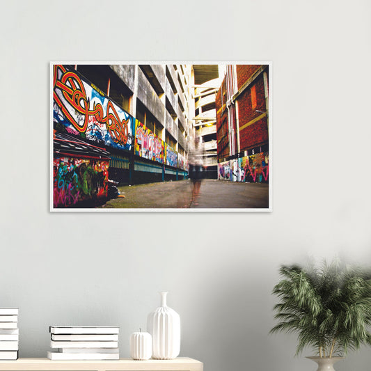 Ghost-like figure walking through graffiti-lined alley in an urban scene full of colour and contrast.