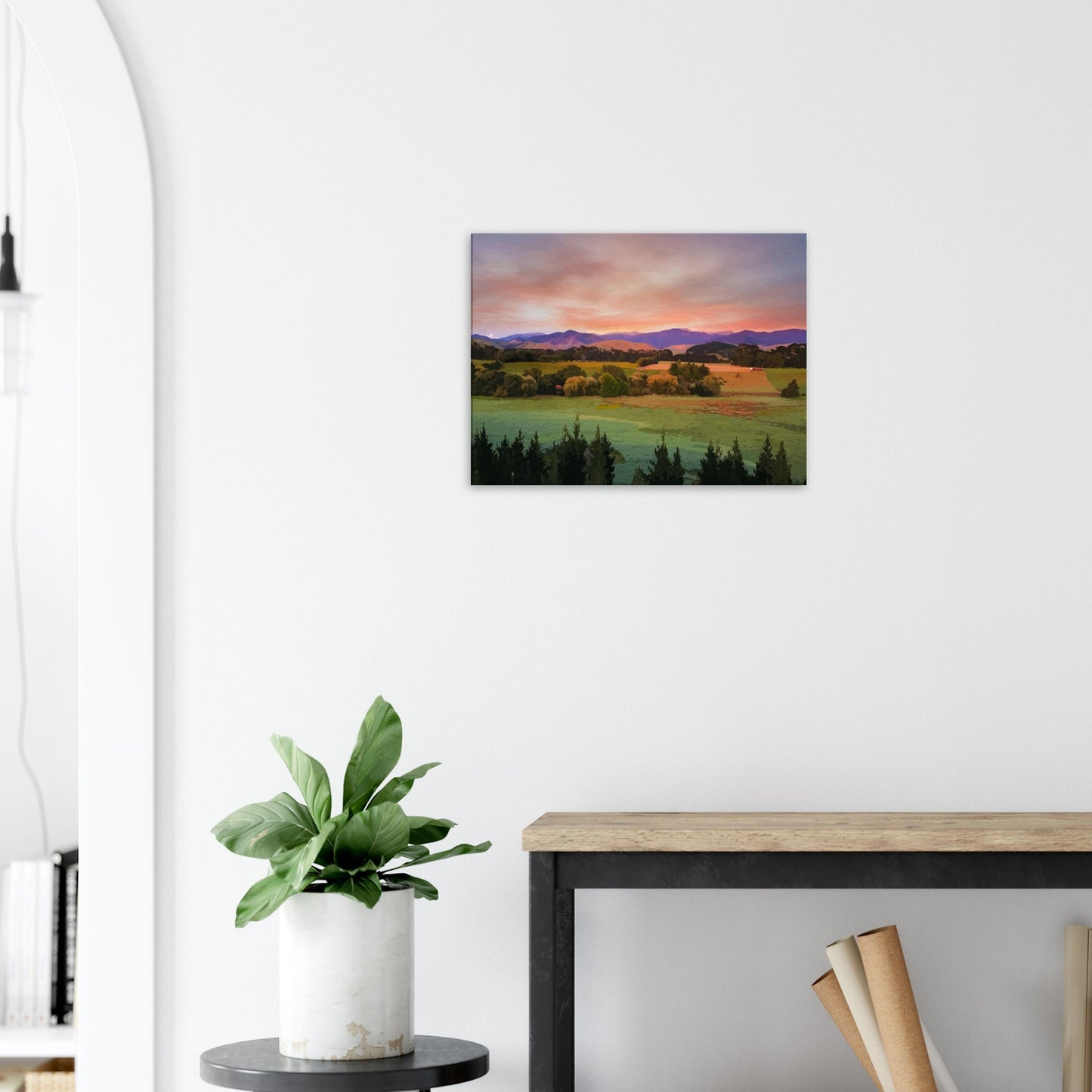Artwork of a Wairarapa sunrise over pine trees and rolling farmland with soft light on the Tararua Ranges.