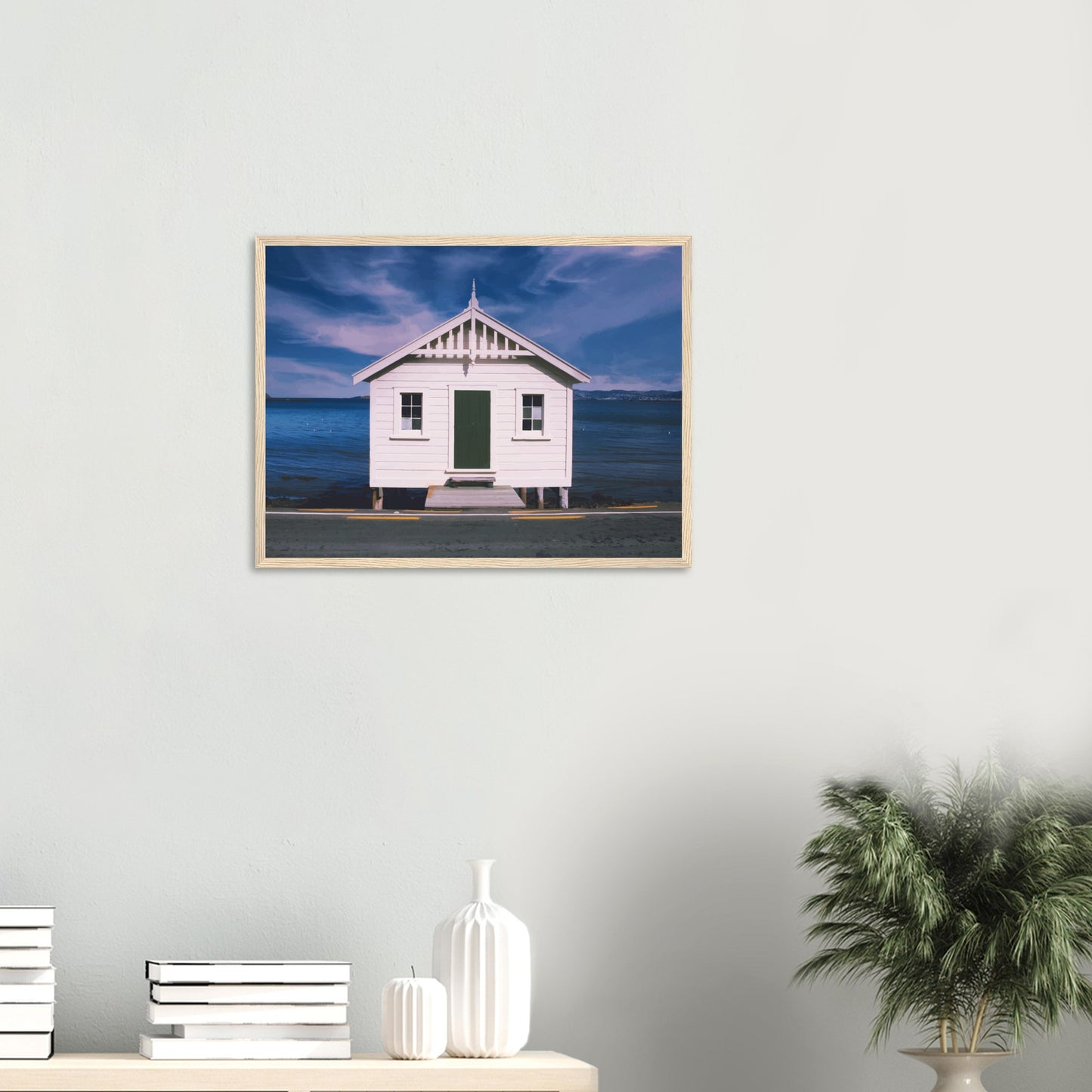 White boat shed by the sea under a blue sky in Eastbourne, New Zealand – bright and coastal.