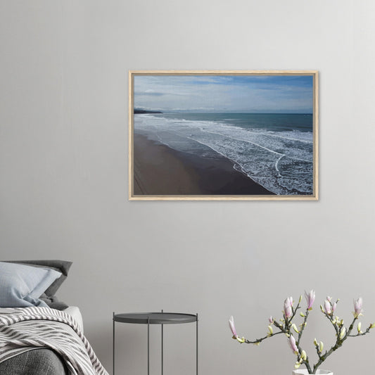 Soft, muted tones of sand, seafoam, and sky blend together in a calming composition, highlighting the natural rhythm of waves lapping the shore.