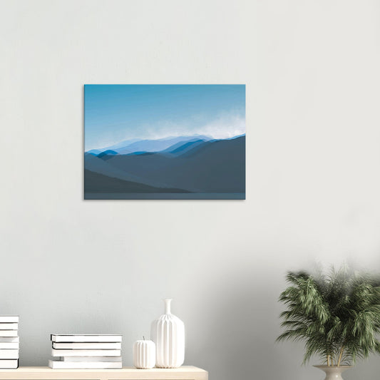 Layered blue mountain ridges fading into mist under a soft sky, evoking calm and simplicity.