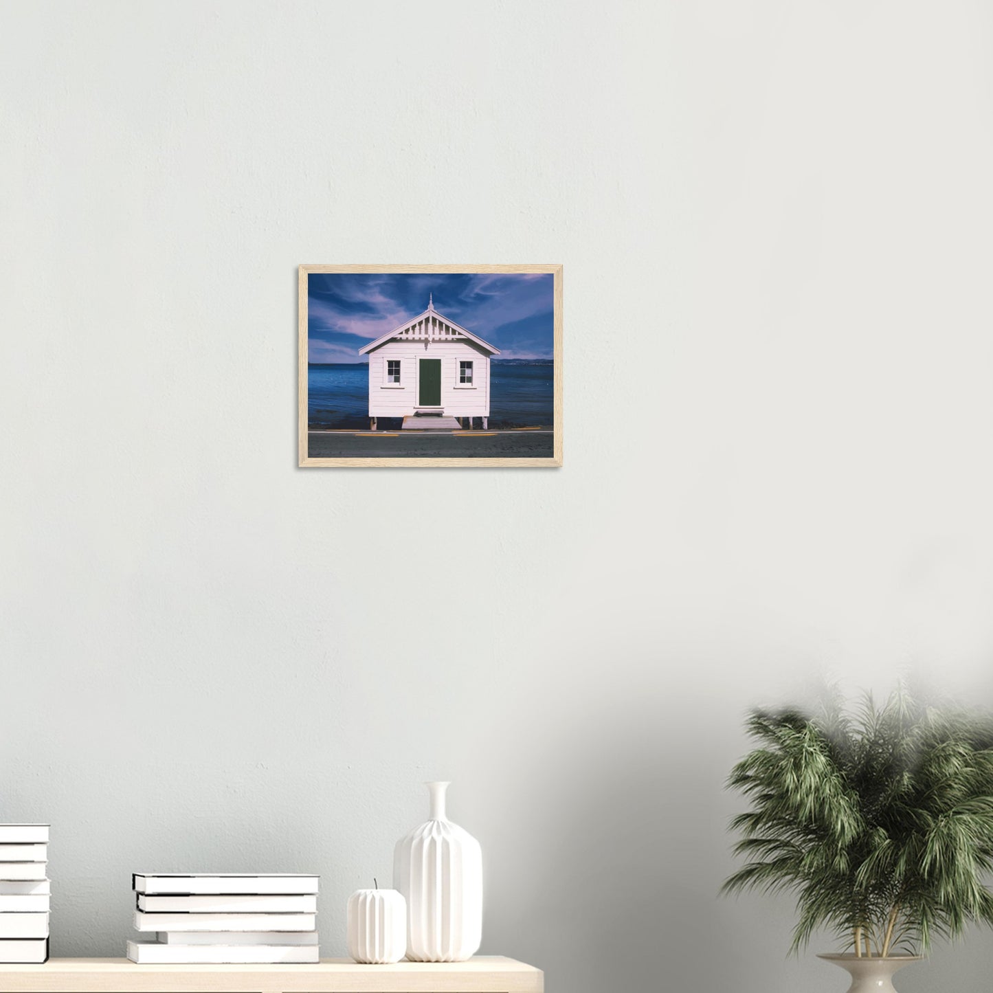 White boat shed by the sea under a blue sky in Eastbourne, New Zealand – bright and coastal.