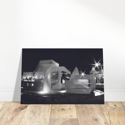 Monochrome artwork of Wellington’s Albatross Fountain lit at night, featuring bold sculptural lines and soft lighting.