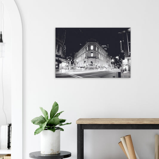 Monochrome artwork of Wellington’s Old Bank Arcade lit up at night, with glowing windows and a classic architectural facade.