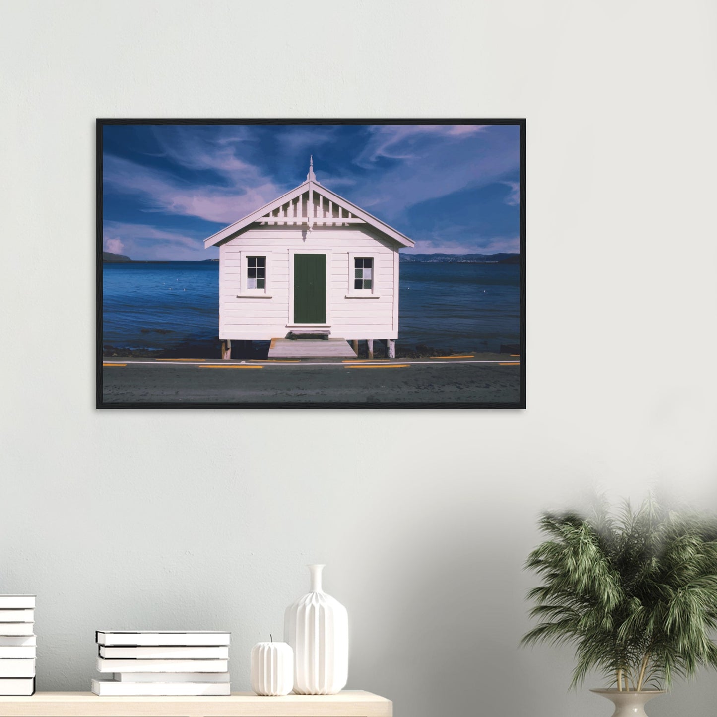 White boat shed by the sea under a blue sky in Eastbourne, New Zealand – bright and coastal.