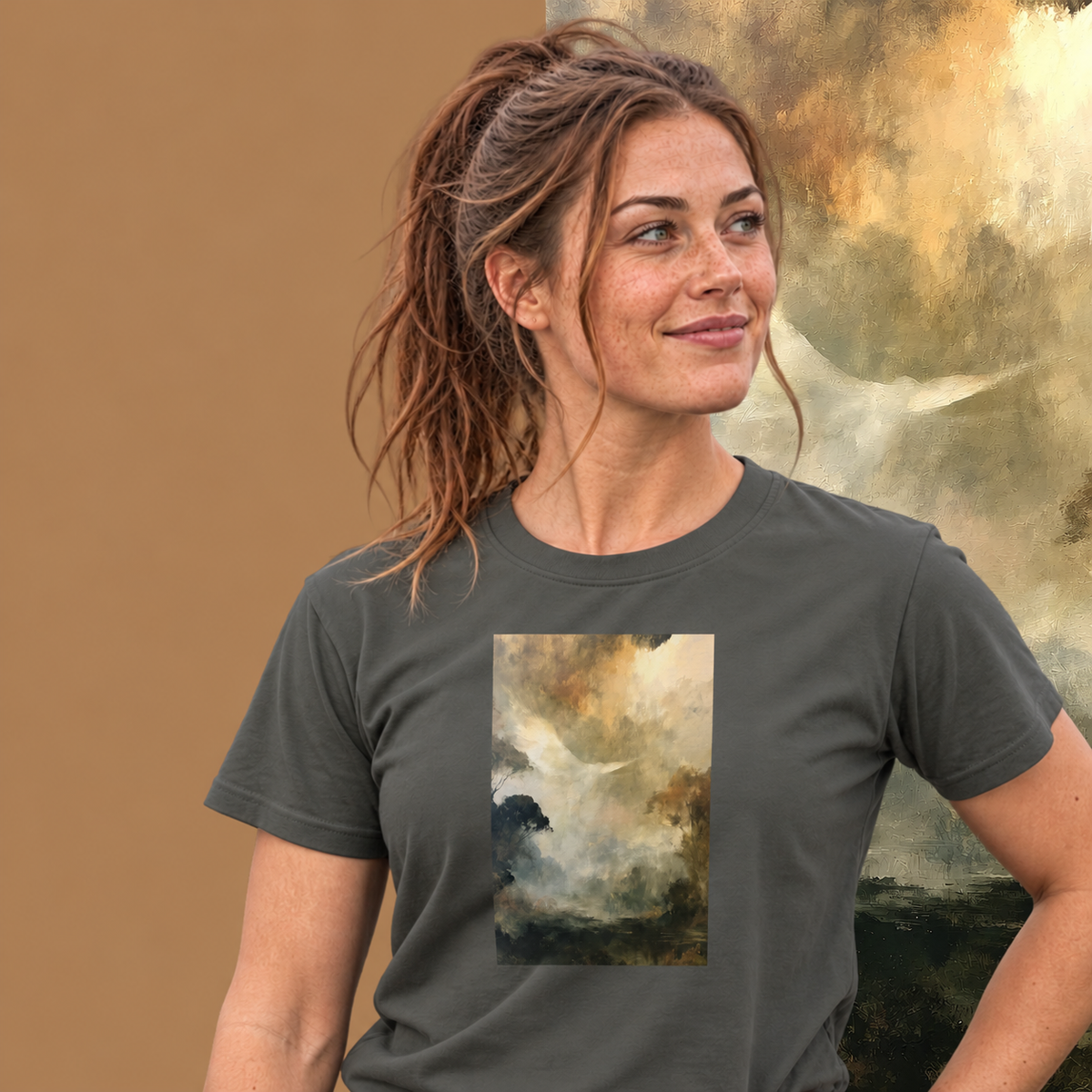 Model wearing the Ascend graphic tee in charcoal, white dove rising through golden mist print - Blend Designs NZ