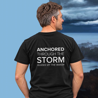 Model wearing the 'Anchored through the storm' back print tee in black, large message printed on the back - Blend Designs NZ
